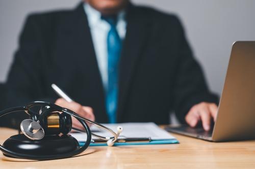 Experienced NJ personal injury lawyer reviewing a client case at his desk