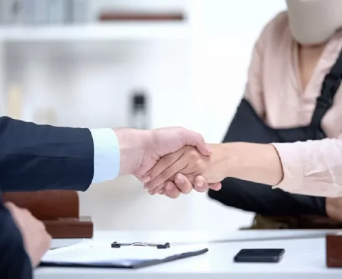 Personal Injury – Header Free NJ injury lawyer shaking hands with client after signing a contingency fee agreement